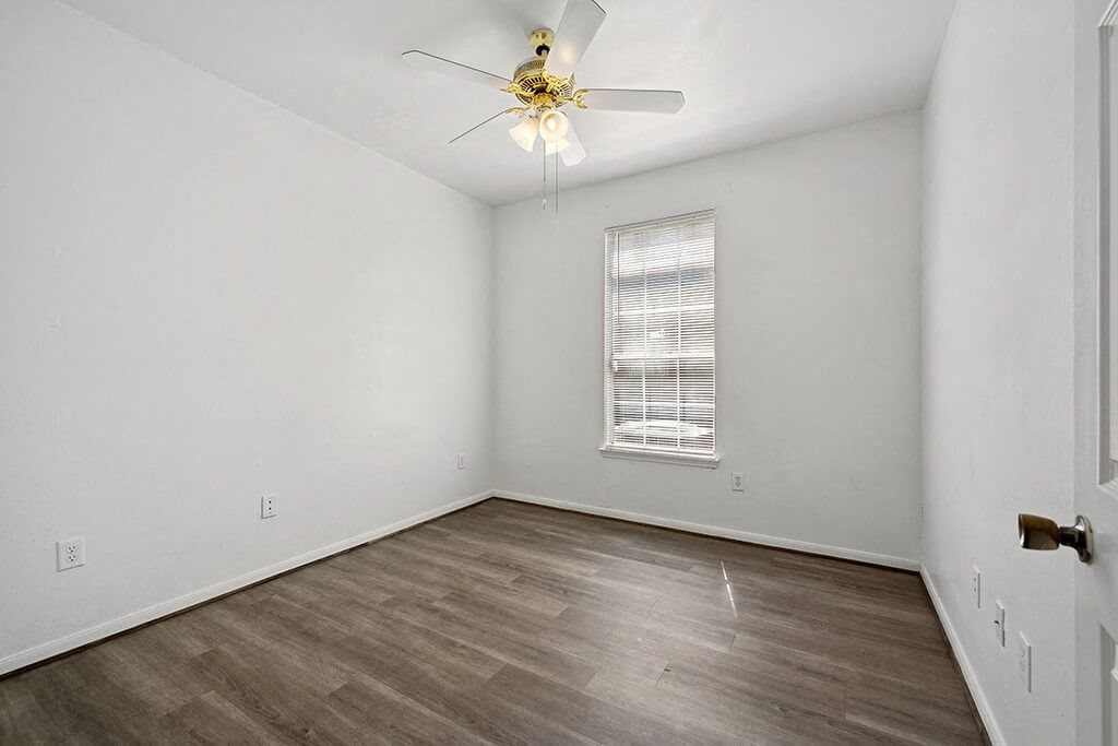 Bedroom with ceiling fan at Fountains at Tidwell and The Enclave in Houston TX